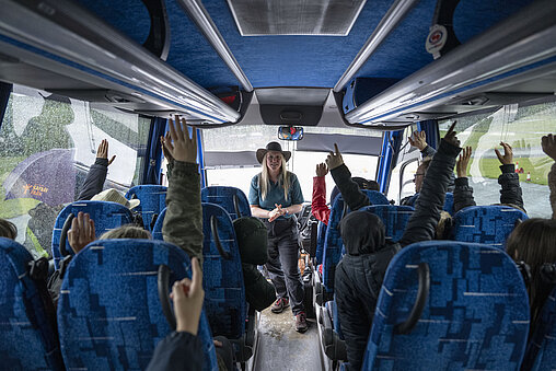 Safari ranger speaking to guests on a coach at West Midlands Safari Park, explaining the wildlife experience and educating them about the animals
