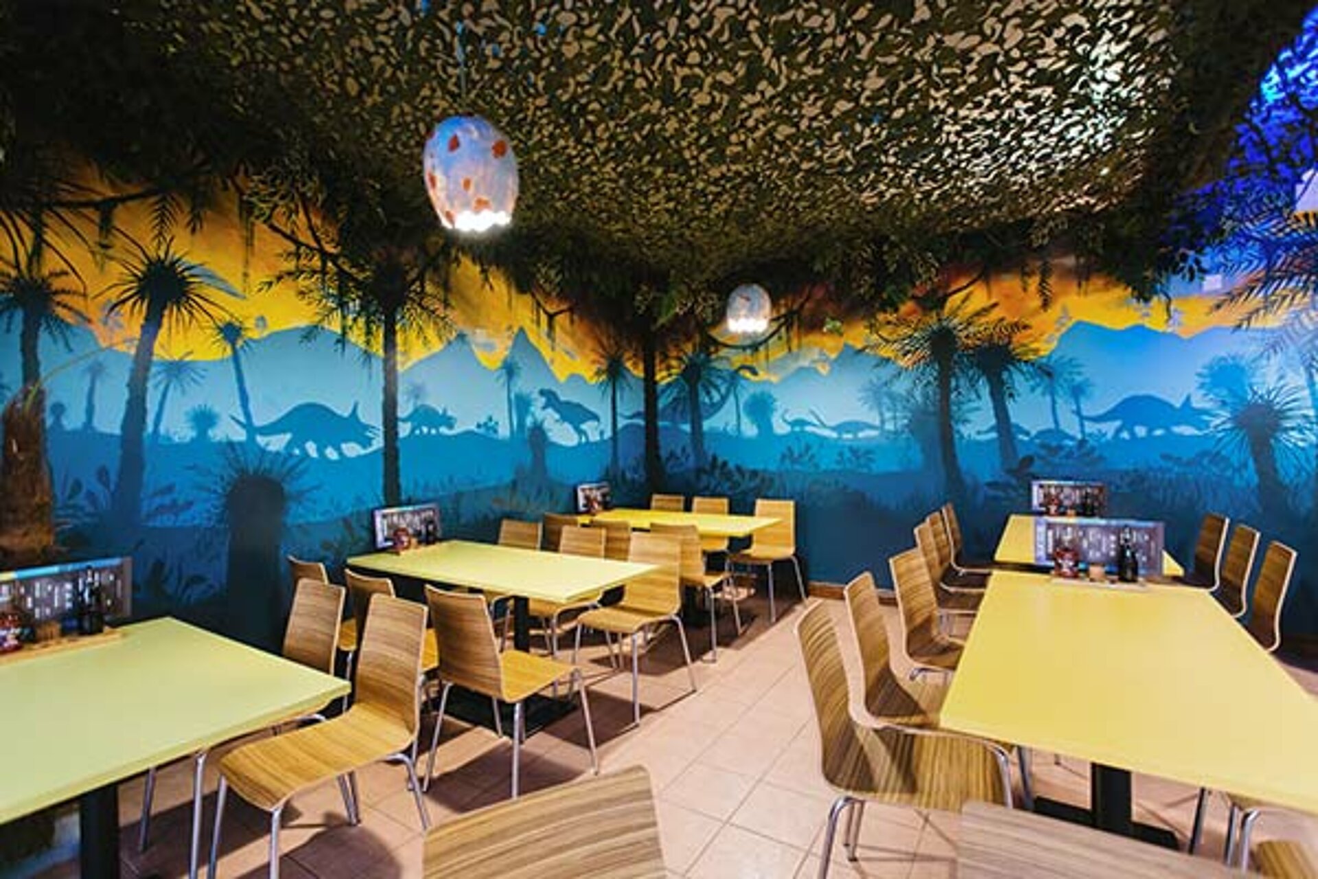Interior of the Dino Diner at West Midlands Safari Park, featuring dinosaur-themed décor, vibrant colors, and family-friendly seating